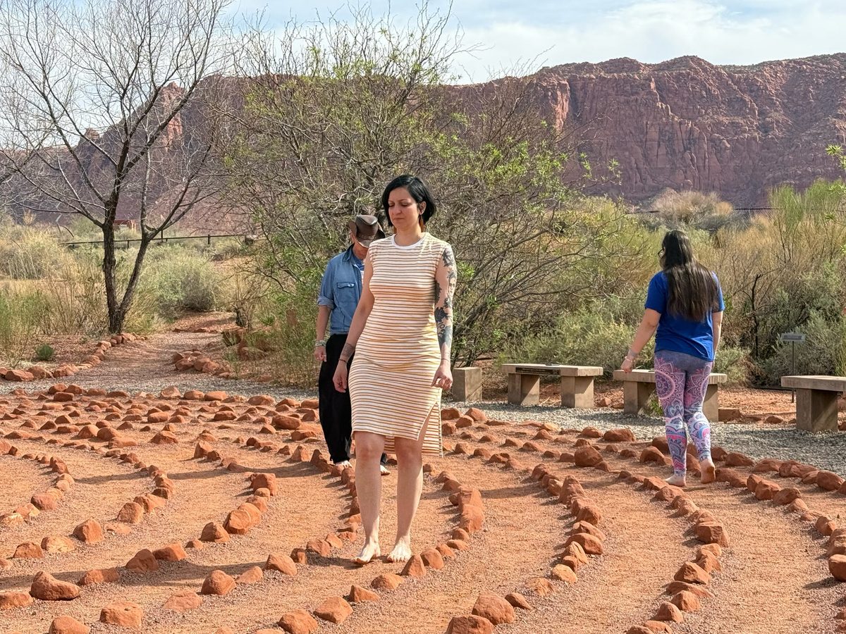 Guests walking meditation labyrinth amid Southern Utah red rocks