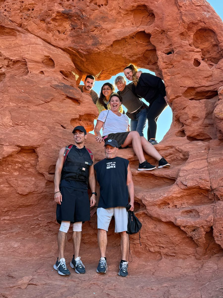 Guest group posing in red rock arch