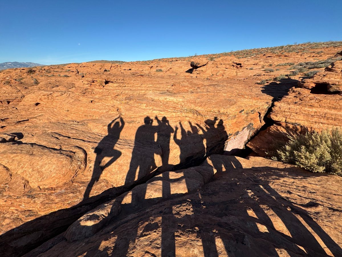 Group of Bridge guests under red rock arch in Southern Utah