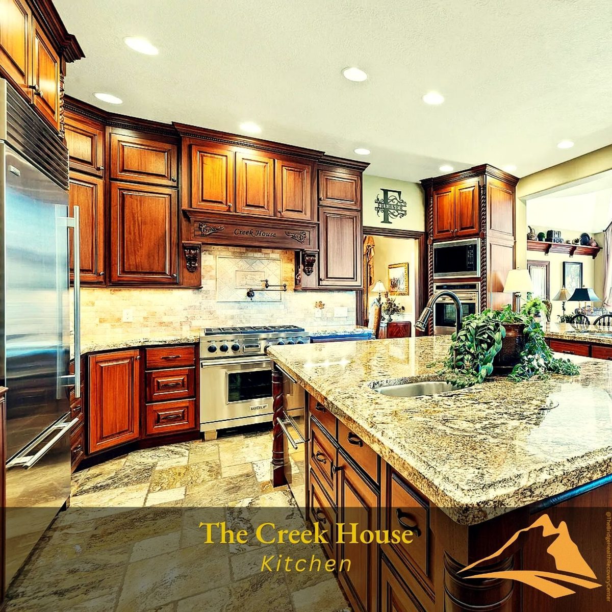 Gourmet kitchen with cherry cabinets and professional range at The Creek House