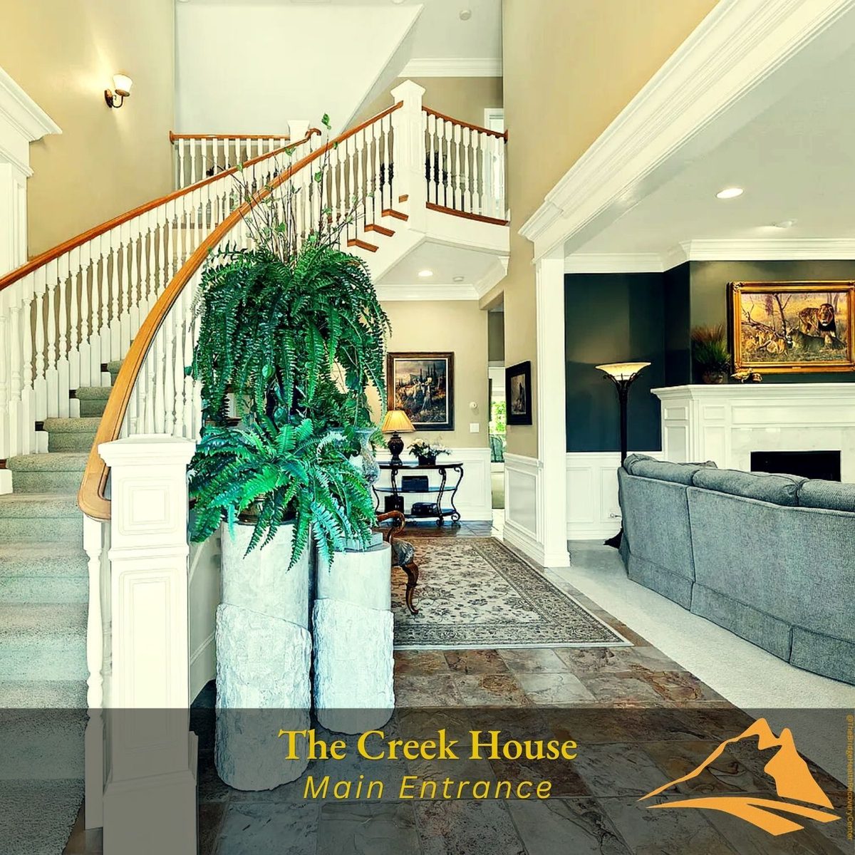 Grand main entrance of The Creek House with curved staircase at The Bridge Health Recovery Center