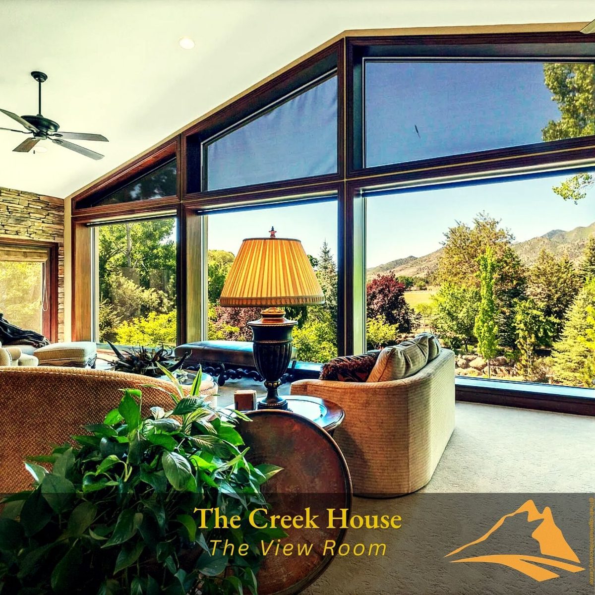 The View Room with panoramic windows overlooking mountains at The Creek House
