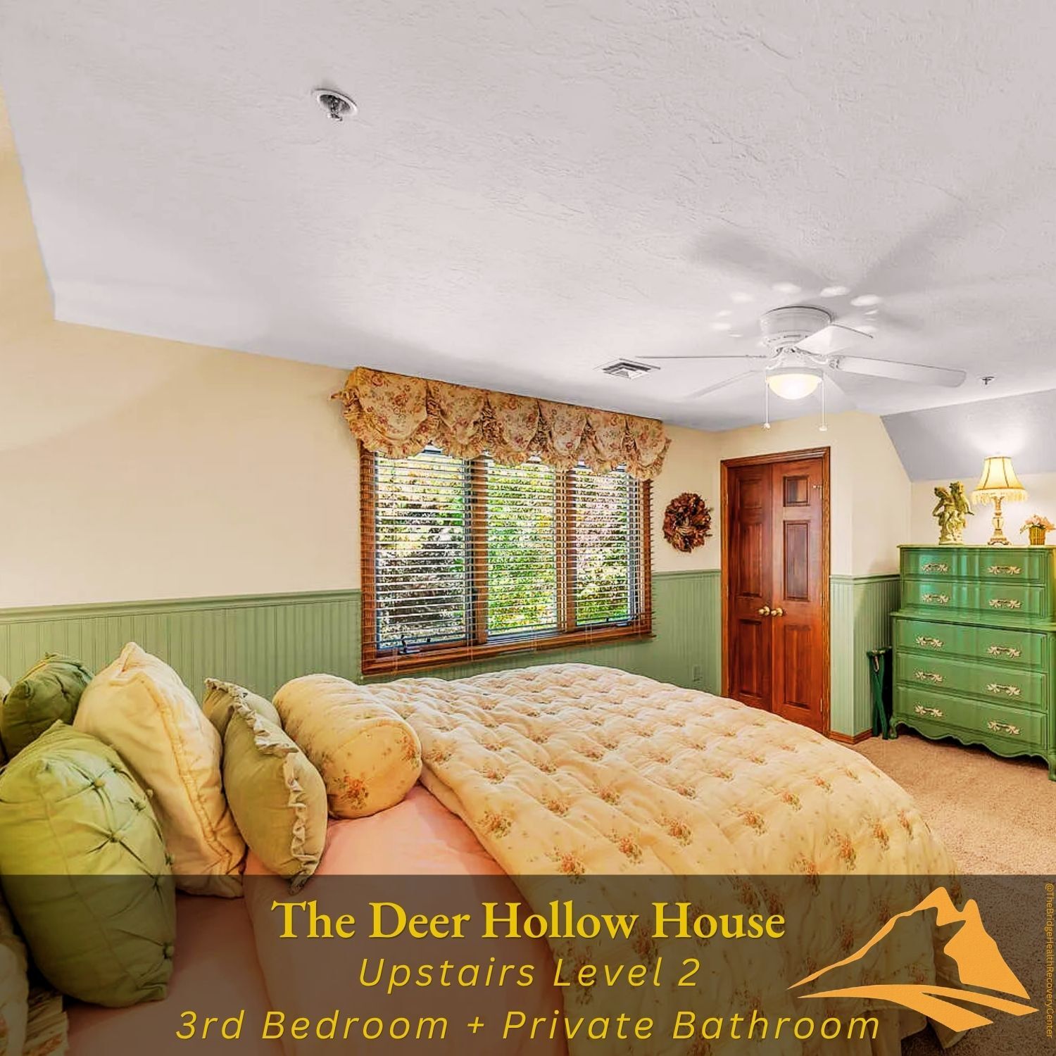 Upstairs bedroom with green wainscoting at The Deer Hollow House